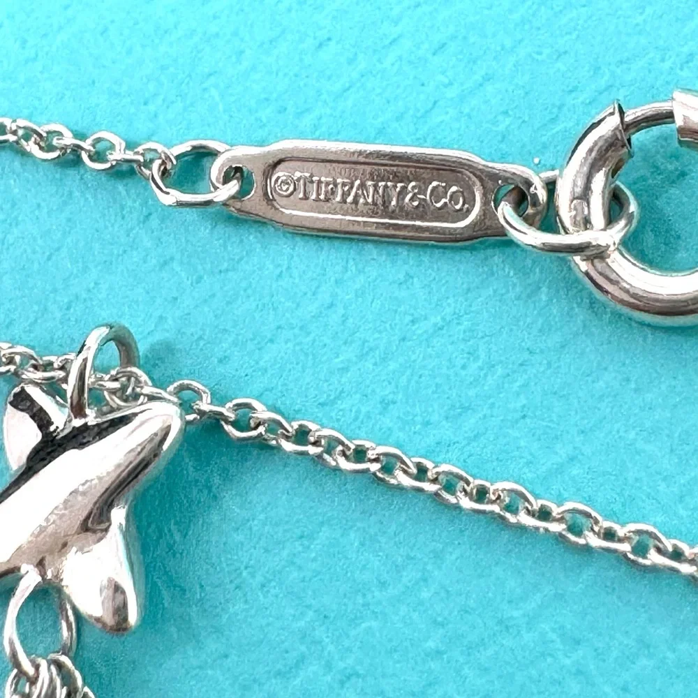 Authentic Tiffany & co. Triple X Kiss Cross Drope Necklace.